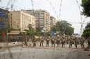 Members of the Republican Guards stand in line at a barricade blocking protesters supporting deposed Egyptian President Mohamed Mursi near a Republican Guards headquarters in Cairo