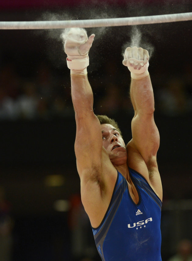 Samuel Mikulak of the U.S. falls as he competes in the horizontal bar event during the men's gymnastics qualification during the London 2012 Olympic Games