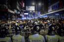 Pro-democracy protesters face police in the Mongkok district of Hong Kong on October 19, 2014