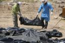 Iraqi security forces work at the site of a mass grave containing the remains of people believed to have been slain by Islamic State (IS) jihadists in Tikrit, on April 12, 2015