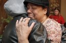 Lisa Williamson, mother of Brandon A. Murray, hugs her son's friend Monday, March 11, 2013, in Warren, Ohio. Investigators spent Monday trying to piece together why eight teenagers were crammed into a speeding SUV without the owner's permission when it flipped over into a pond, killing six of them, including Murray. (AP Photo/Tony Dejak)