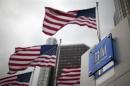 Flags wave behind a General Motors Corp sign in downtown in Detroit