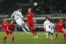 Swansea City's Gylfi Sigurdsson has a header at goal against Liverpool during their English Premier League soccer match at the Liberty Stadium, in Swansea, England, Monday March 16, 2015. (AP Photo / David Davies, PA) UNITED KINGDOM OUT - NO SALES - NO ARCHIVE