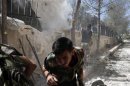 A Syrian rebel fires towards a pro-government sniper in the Seif El Dawla district in the center of Aleppo city