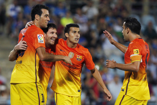 FC Barcelona's Lionel Messi from Argentina, second left, celebrates his goal with team mates during a Spanish La Liga soccer match against Getafe at the Coliseum Alfonso Perez stadium in Getafe, near Madrid, Spain, Saturday, Sept. 15, 2012. (AP Photo/Andres Kudacki)
