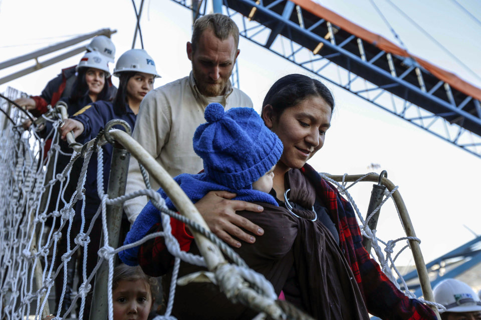 Hannah Gastonguay, holding her baby Rahab, is followed by her husband Sean and the couple's 3-year-old daughter Ardith, as they disembark in the port city of San Antonio, Chile, Friday, Aug. 9, 2013. The northern Arizona family was lost at sea for weeks in an ill-fated attempt to leave the U.S. over what they consider government interference in religion. But just weeks into their journey the Gastonguays hit a series of storms that damaged their small boat, leaving them adrift for weeks. They were eventually picked up by a Venezuelan fishing vessel, transferred to a Japanese cargo ship and taken to Chile where they are resting in a hotel in San Antonio. (AP Photo/Las Ultimas Noticias)