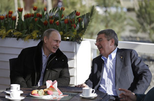 Vladimir Putin, left, and IOC President Thomas Bach sit at a cafe near the Olympic Park in Sochi. (AP)