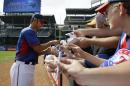 Texas Rangers' Yu Darvish of Japan signs autographs for fans before an opening day baseball game against the Philadelphia Phillies, Monday, March 31, 2014, in Arlington, Texas. (AP Photo/Tony Gutierrez)