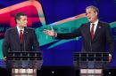 FILE - In this Dec. 15, 2015 file photo, former Florida Gov. Jeb Bush, right, makes a point as Sen. Ted Cruz, R-Texas listens on during the Republican presidential debate in Las Vegas. Ted Cruz once proudly wore a belt buckle reading 