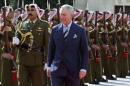 Britain's Prince Charles reviews an honour guard before a meeting with Jordan's King Abdullah at the Royal Palace in Amman