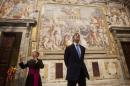 U.S. Secretary of State Kerry looks up towards an artwork during a tour of a section of the Vatican with Chief of Protocol Monsignor Bettencourt