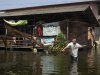 A Thai resident throws his net to catch fish at a floods area in Phisi Charoen district in Bangkok, Thailand, Saturday, Nov. 12, 2011. Thailand's Prime Minister Yingluck Shinawatra has struck a note of partial optimism over the floods plaguing her country, saying that if the water penetrates into the capital's central districts, it will not be too deep. (AP Photo/Sakchai Lalit)