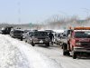 Traffic is backed up on the Long Island Expressway just west of Exit 59 Ocean Avenue as payloaders clear snow from the road after a storm, Saturday, Feb. 9, 2013, in Ronkonkoma , N.Y. (AP Photo/Kathy Kmonicek)