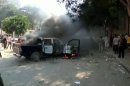 Demonstrators set police car on fire in Cairo