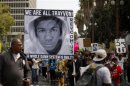 People carry a photo of Trayvon Martin during a march to protest the verdict in the Zimmerman trial in Los Angeles