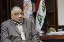 Iraq's Oil Minister Mehdi speaks with Kirkuk Governor Karim on the outskirts of Kirkuk