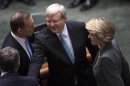 Australian Prime Minister Kevin Rudd (C) greets members of the Opposition including Opposition Leader Tony Abbott (L) and Deputy Leader Julie Bishop before Parliament starts at the Parliament House in Canberra June 27, 2013. REUTERS/Andrew Taylor