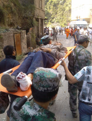 In this photo provided by Xinhua News Agency, an injured villager is carried on a stretcher by rescuers following an earthquake in Luozehe Town, Yiliang County, southwest China's Yunnan Province, Friday, Sept. 7, 2012. A series of earthquakes collapsed houses and triggered landslides in a remote mountainous part of southwestern China on Friday, killing dozens of people with the toll expected to rise. Damage was preventing rescuers from reaching some outlying areas, and communications were disrupted. (AP Photo/Xinhua, Zhou Hongpeng) NO SALES