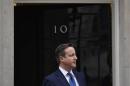 Britain's PM Cameron waits to greet Cyprus's President Anastasiades at Cameron's official residence in Downing Street in central London