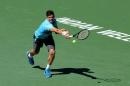 Milos Raonic of Canada hits a return to Andy Murray of Great Britain during the BNP Paribas Open at Indian Wells Tennis Garden on March 12, 2014 in Indian Wells, California