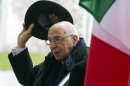 File photo of Italian President Napolitano lifting his hat as he meets with German Chancellor Merkel for talks at the Chancellery in Berlin