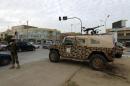 A Libyan soldier and army vehicle are deployed in the streets of central Benghazi on November 19, 2013
