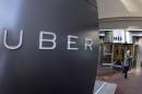 FILE - In this Dec. 16, 2014, file photo a man leaves the headquarters of Uber in San Francisco. Uber said Wednesday, June 1, 2016, that it is getting a massive cash infusion from Saudi Arabia. (AP Photo/Eric Risberg, File)