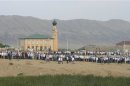 People gather before the funeral of Atsayev, a leading Sufi Muslim cleric, in the village of Chirkey in the Republic of Dagestan