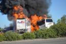 File - In this April 10, 2014, file photo, massive flames engulf a tractor-trailer and a tour bus just after they collide on Interstate 5 near Orland, Calif. Authorities are releasing 911 calls made after a FedEx struck slammed into a tour bus carrying high school students last week, killing 10 people. The crash is under investigation by state and federal officials who are trying to determine why the truck driver careened across an Interstate-5 median and struck the bus, leaving no tire marks to suggest he tried to brake. (AP Photo/Jeremy Lockett, File)