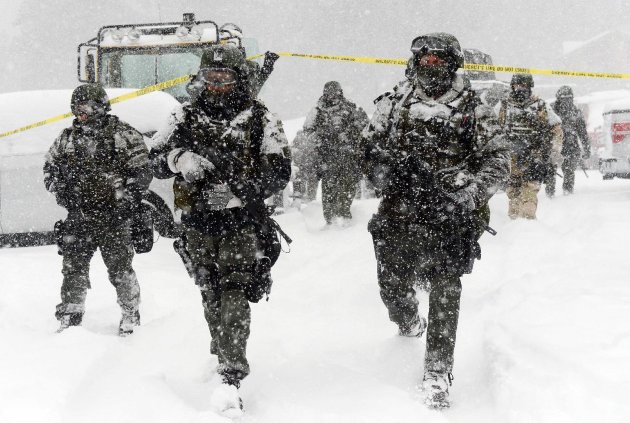 A San Bernardino County Sheriff SWAT team returns to the command post at Bear Mountain near Big Bear Lake, Calif. after searching for Christopher Jordan Dorner on Friday, Feb. 8, 2013. Search conditions have been hampered by a heavy winter storm in the area. Dorner, a former Los Angeles police officer, is accused of carrying out a killing spree because he felt he was unfairly fired from his job. (AP Photo/Pool, The Inland Valley Daily Bulletin, Will Lester)
