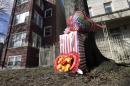A makeshift memorial is seen in Chicago, Tuesday, March 12, 2013, at the site where 6-month-old girl Jonylah Watkins, and her father, a known gang member, were shot Monday, March 11. The girl, who was shot five times, died Tuesday morning. She became the latest homicide victim of a bloody gang war in Chicago when a man approached a van in which her father was changing her diaper and opened fire. Her father, Jonathan Watkins, was in serious but stable condition. (AP Photo/M. Spencer Green)