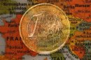 A picture illustration taken with the multiple exposure function of the camera shows a one Euro coin and a map of Europe