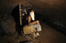 A Palestinian smuggler rests inside a tunnel beneath the Egyptian-Gaza border in Rafah