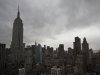 Storm clouds loom over the Empire State Building and Manhattan skyline, Monday, Oct. 29, 2012, in New York. Hurricane Sandy continued on its path Monday, forcing the shutdown of mass transit, schools and financial markets, sending coastal residents fleeing, and threatening a dangerous mix of high winds and soaking rain.  (AP Photo/ John Minchillo)