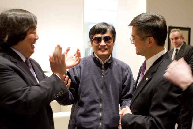In this photo released by the US Embassy Beijing Press Office, blind lawyer Chen Guangcheng, center, holds hands with U.S. Ambassador to China Gary Locke, right, as U.S. State Department Legal Advisor Harold Koh, left, applauds, before leaving the U.S. embassy for a hospital in Beijing Wednesday May 2, 2012. (AP Photo/US Embassy Beijing Press Office, HO)