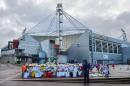 A man looks at flowers and tributes left in memory of former Preston North End and England footballer Sir Tom Finney, outside the Deepdale stadium in Preston, north west England, on February 27, 2014