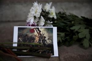 A postcard and flowers are left in tribute to victims&nbsp;&hellip;