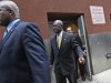 Republican presidential candidate Herman Cain is escorted by security as he leaves the back door of the Russian Tea Room after a fundraiser,  Friday, Nov. 11, 2011, in New York.  (AP Photo/Mary Altaffer)