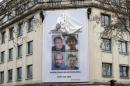 A poster calling for the release of French journalists Didier Francois, Edouard Elias, Nicolas Henin and Pierre Torres is installed on the facade of the Ile de france regional council headquarters in Paris