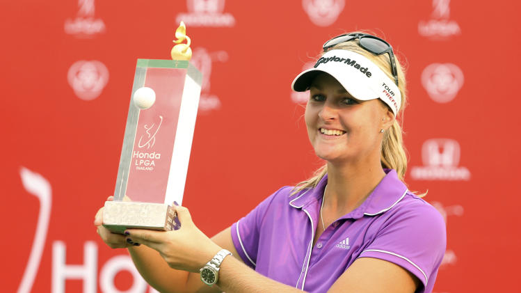 Anna Nordqvist of Sweden shows off her winner&#39;s trophy during the awarding ceremony of the LPGA Thailand golf tournament in Pattaya, southern Thailand, Sunday, Feb. 23, 2014.(AP Photo/Siamsport Newspaper) THAILAND OUT