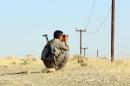 An Iraqi Peshmerga fighter scans the area as he holds a position at a post near the jihadist-held city of Zumar in Mosul province on September 4, 2014
