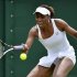 Venus Williams of the U.S. hits a return to Elena Vesnina of Russia during their women's singles tennis match at the Wimbledon tennis championships in London