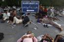 Supporters of Mohammad Tahir ul-Qadri, Sufi cleric and leader of political party Pakistan Awami Tehreek (PAT), sleep at the entrance of the parliament house in Islamabad