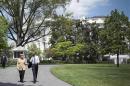 U.S. President Obama and German Chancellor Merkel walk following their meeting to the herb and vegetable garden of the White House in Washington
