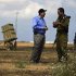 U.S ambassador to Israel Shapiro listens to an Israeli army colonel as they stand next to a launcher in a field near the southern city of Ashkelon