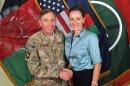 FILE - This July 13, 2011, photo made available on the International Security Assistance Force's Flickr website shows the former Commander of International Security Assistance Force and U.S. Forces-Afghanistan Gen. Davis Petraeus, left, shaking hands with Paula Broadwell, co-author of his biography "All In: The Education of General David Petraeus." The affair between retired Army Gen. David Patraeus and author Paula Broadwell is but an extreme example of the love/hate history between biographers and their subjects. (AP Photo/ISAF, file)