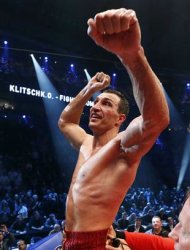 Ukrainian WBO, IBO, IBF and WBA heavyweight boxing world champion Vladimir Klitschko gestures as he celebrates his victory over Polish challenger Mariusz Wach after their title bout in Hamburg November 10, 2012. World heavyweight champion Klitschko was made to go the distance against Wach but earned a unanimous points decision on Saturday to retain his four title belts. REUTERS/Morris Mac Matzen