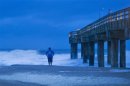 Sicinski looks at storm surf before sunrise in St. Augustine Beach, Florida, as Tropical Storm Sandy, downgraded overnight, passes offshore