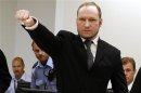 Norwegian mass killer Breivik gestures as he arrives at the court room in Oslo Courthouse