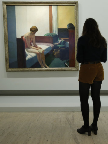 A woman looks at "Hotel Room, 1931" as part of the retrospective of Edward Hopper, one of the great American 20th century artists at Paris’ Grand Palais Museum, in Paris, Monday, Oct. 8, 2012. This major Hopper retrospective reveals that the 20th century painter known for his rendering of American life, also drew inspiration from France, and includes some 128 Hopper works, such as the masterpieces “Nighthawks” and “Soir Bleu”. (AP Photo / Francois Mori)
